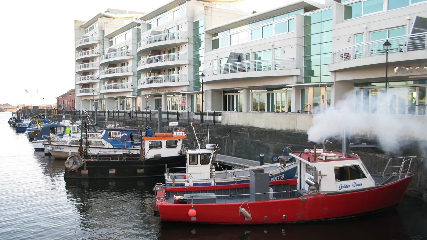 Sovereign Quay seen from across the water, with boats moored in front
